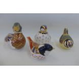 Four assorted Royal Crown Derby paperweights including a red legged partridge, a blue tit, a coal