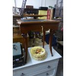 A handmade mahogany glazed display case with single drawer, raised on sabre front supports.