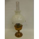 A brass oil lamp with opaque white mushroom shade and clear glass funnel.