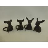 Four cast metal seated mice.