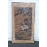 A large Oriental study of two standing cranes, signed, set within a faux bamboo frame, 33 3/4 x 60