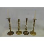 Two pairs of brass open twist candlesticks, two with petaled bobeches decorated with knights on