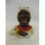 A cast metal novelty money box in the form of a native African woman.