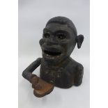 A late 19th Century/ early 20th Century cast metal novelty money box of a native African.