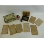 An assortment of mixed collectables including early continental cloth road maps.