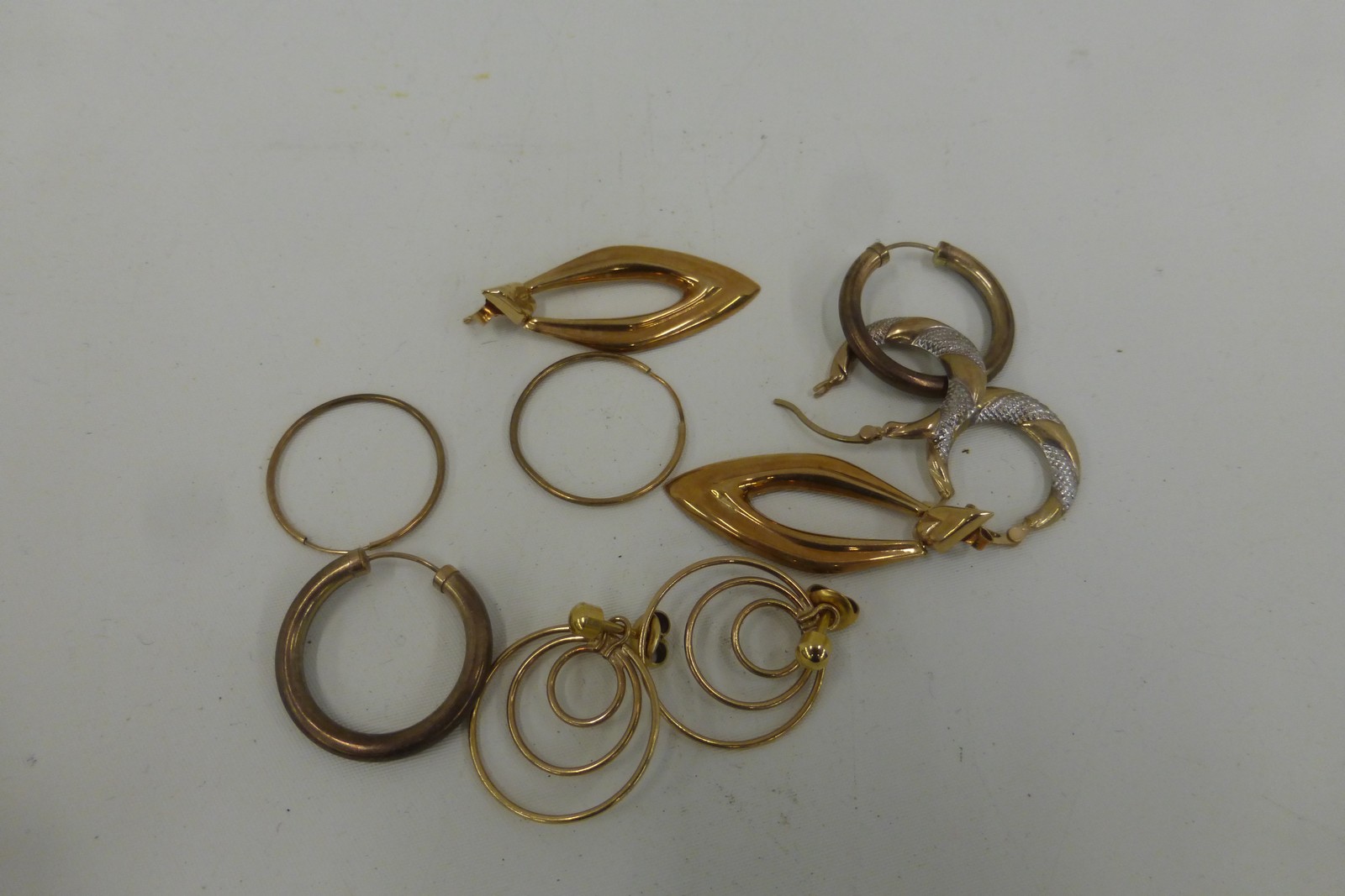 Five pairs of assorted 9ct gold hooped earrings, total weight 9.7g.