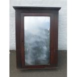 A good quality early 19th Century Empire style mirror fronted cabinet, the door flanked by fluted