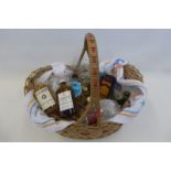 A basket of assorted miniature spirits, beer mats, glasses etc.