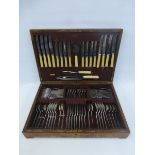 A wooden cased eight setting canteen of cutlery with rat tail decoration, possibly 1930s.