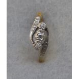 An 18ct gold and platinum three stone diamond ring, in the Edwardian style.