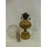 A decorative brass Hinks & Sons oil lamp base with pierced decoration, with etched glass shade and