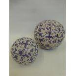 Two ceramic blue and white carpet balls.
