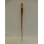 A 19th Century exotic wooden walking/hiking stick with ivory knop.