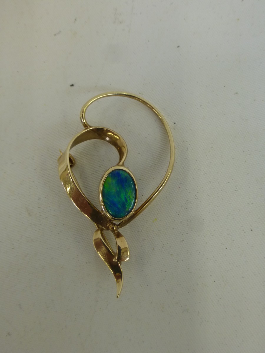 A 9ct gold brooch set with an ocean blue opal.