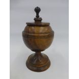 An 18th Century/19th Century style walnut treen spicebox/lidded urn with ebonised finial.