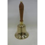 A brass hand bell stamped APP.