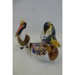A Royal Crown Derby penguin, mallard duck both with silver stoppers, and a pelican, gold stopper.