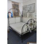 A Victorian polished brass and painted metal double bed, with hooped ends.