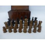 A 19th Century rosewood and boxwood chess set contained in a 19th Century mahogany lidded box, the