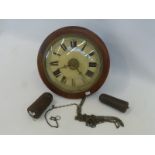 A 19th Century circular mahogany cased post office alarm wall clock with drop down pendulum and