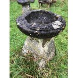 A large period stone staddle stone with reconstituted bird bath as the cap.