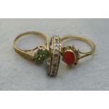 Two 9ct gold rings set with coral and an emerald.