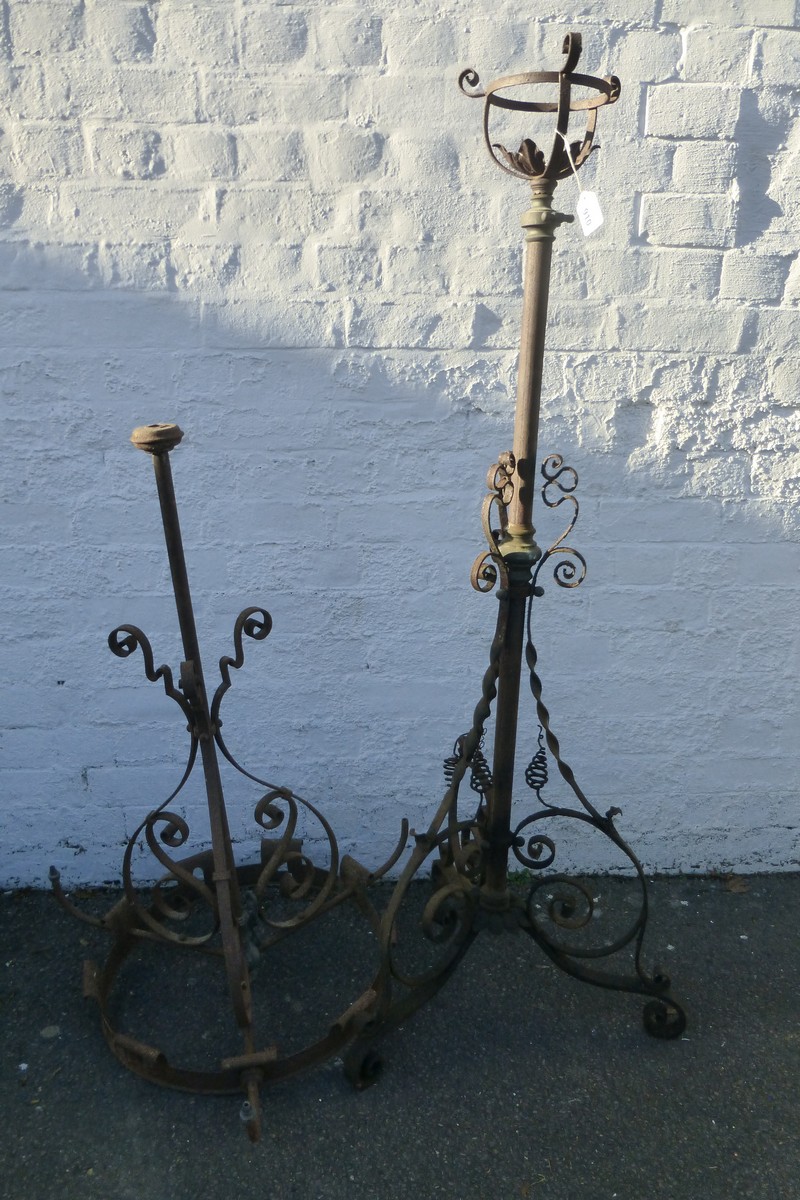 A metal telescopic oil lamp stand and a gas ceiling chandelier.