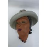 A Jon Douglas Art Deco wall mask special colour - pale grey blue cyclamen, Regd. No. 3377, made in