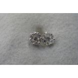 A pair of 9ct white gold diamond stud earrings, the centre stone surrounded by a further six