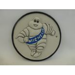 A circular cast metal Michelin wall plaque.