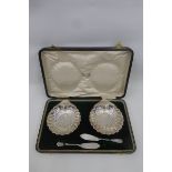 A pair of cased shell shaped butter dishes, maker - Harrison Brothers & Howson, Sheffield 1904.