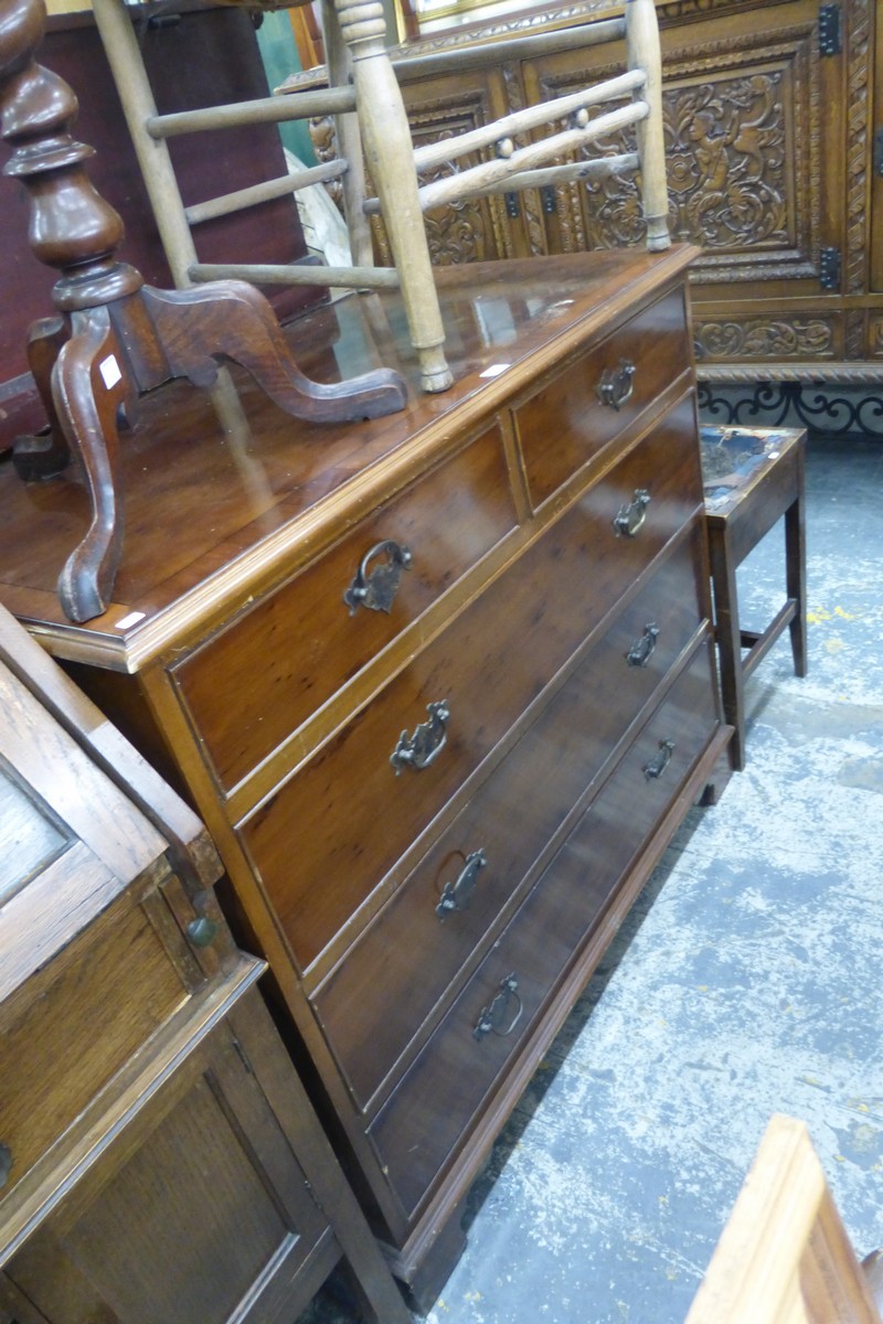 A yew wood chest of two short over three long drawers, raised on bracket supports.