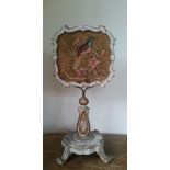 A Regency decorative painted and gilded carved wood table screen with embroidered exotic bird.