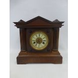 A wooden cased mantel clock with internal label inscribed H.A.C. 14 Day Strike No. 3100.