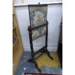 A Regency rosewood fire screen with central rising tapestry panel, raised on turned reeded supports,