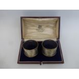 A cased pair of silver napkin rings, maker Hamilton and Inches, Edingburgh 1922-23, in original