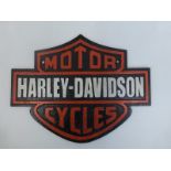 A cast metal wall mounted motorbike plaque.