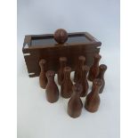 A desk top wooden cased skittles game.