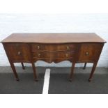 An Edwardian style mahogany serpentine fronted side board of two central drawers flanked by two