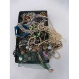 A box of assorted costume jewellery of various ages and styles.