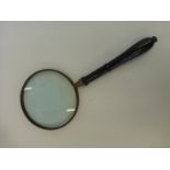 A large handheld magnifying glass.