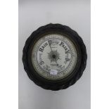 An oak framed Aneroid barometer inscribed A. Casartelli 54 Old Hall St. Liverpool.