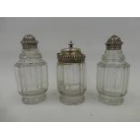A set of three 19th Century silver topped and glass condiments - salt, pepper and mustard.