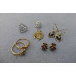 An assortment of 9ct gold earrings including a 9ct gold horseshoe pendant, two rings etc.