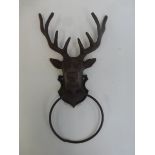 A wall mounted cast metal deer's head with ring tie.