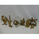 An assortment of brass figures including a showjumper, rams, owls. birds, hedgehog etc.