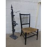 An Edwardian ebonised and rush seated side chair plus a wall mounted pub sign hanging flange.