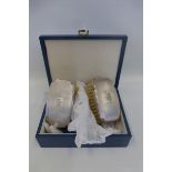 A pair of cased silver backed hair brushes with engine turned decoration, maker - W.I. Broadway &