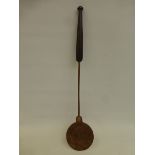 An 18th Century copper hand forged spoon/stirer with hand beaten decoration and a mahogany handle.