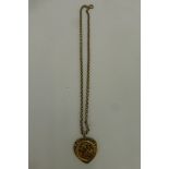 A 9ct gold pendant necklace with a half gold sovereign set in a heart shaped mount, total weight